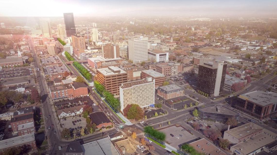 Rendering of Town Branch Commons in downtown Lexington, featuring an urban trail and separate bike lane with trees and shrubs that will dot the more than 2-mile section of the trail.