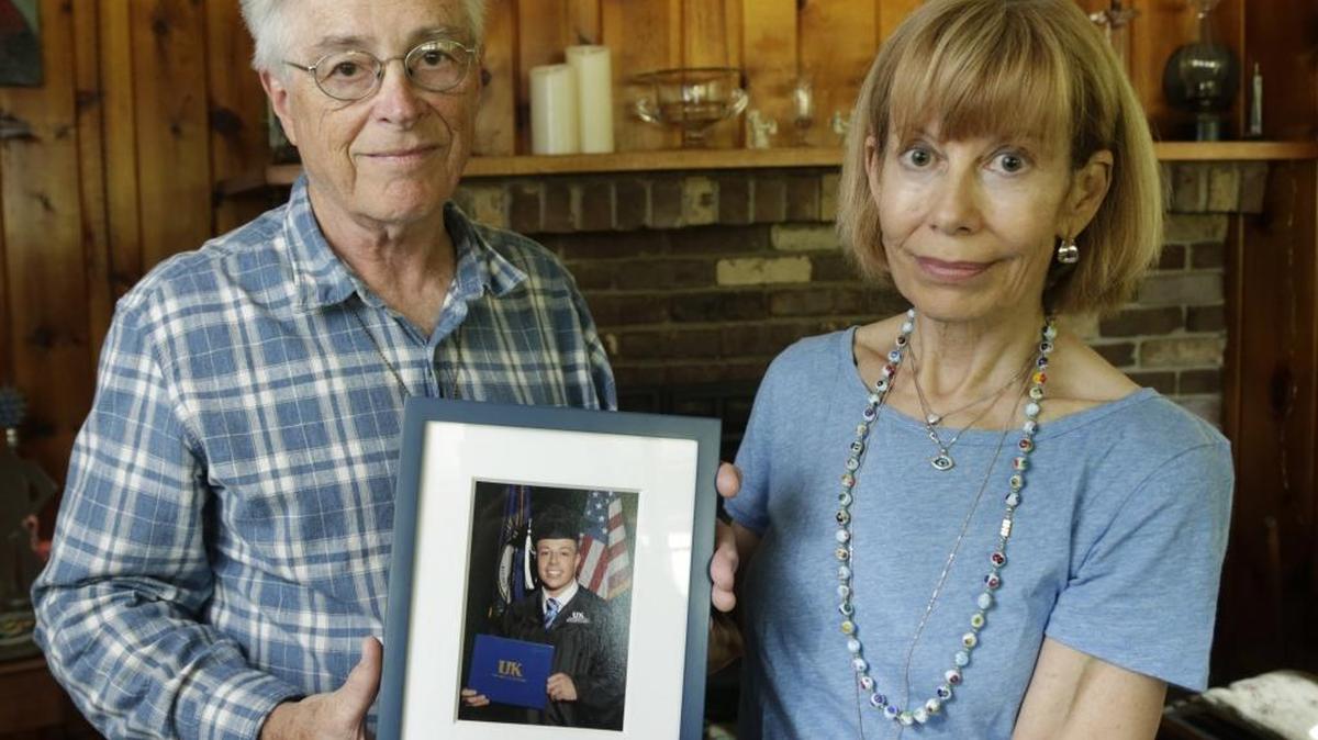 Jim Cagey and Anne Roberts held a graduation portrait of their son Patrick at their home in the Lansdowne neighborhood of Lexington. Patrick died four years ago when he overdosed. They are starting a local chapter of a support group open to anyone who has a loved one who has died of an overdose.