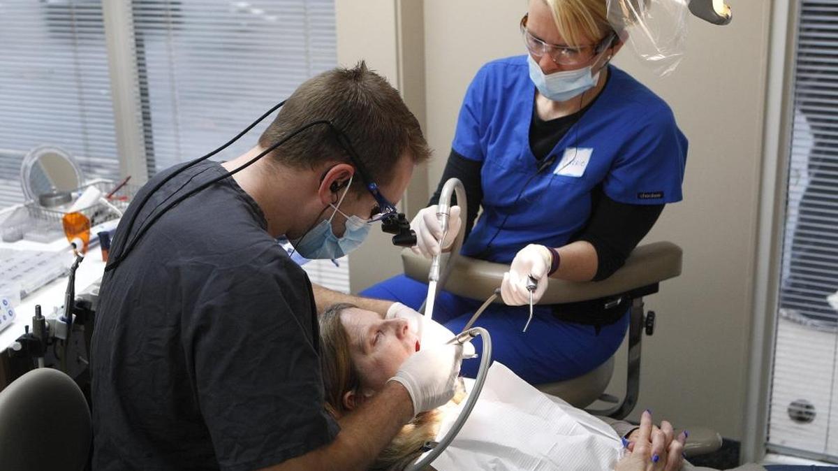 Dr. John Weaver, left, and dental assistant Carrie Humble worked on Joanne Ross during a day of free dental care at Commonwealth Smiles in Lexington.