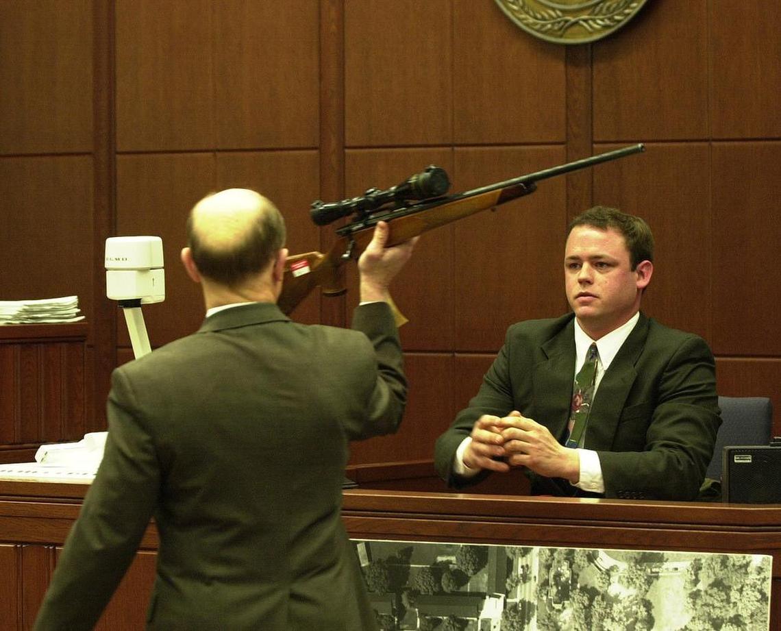 Andy Hulette, right, a former roommate of Shane Ragland, who is on trial for the murder of Trent DiGiuro, a University of Kentucky football player in July 1994 testified in the trial that enter it’s third week in Fayette Circuit Court on Monday, March 25, 2002. Hullett testified that Ragland had told him about the events on the night of the murder when a party to celebrate DiGiuro’s upcoming 21st birthday was taking place a couple of doors from where they lived. Hulette identified the rifle, believed to have been used, as Fayette Commonwealth’s Attorney Ray Larson held it up and that it is the same rifle that Ragland kept at their home.