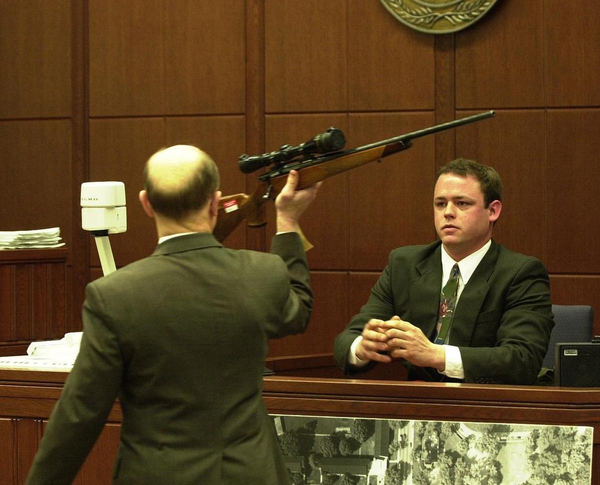 Andy Hulette, right, a former roommate of Shane Ragland, who is on trial for the murder of Trent DiGiuro, a University of Kentucky football player in July 1994 testified in the trial that enter it’s third week in Fayette Circuit Court on Monday, March 25, 2002. Hullett testified that Ragland had told him about the events on the night of the murder when a party to celebrate DiGiuro’s upcoming 21st birthday was taking place a couple of doors from where they lived. Hulette identified the rifle, believed to have been used, as Fayette Commonwealth’s Attorney Ray Larson held it up and that it is the same rifle that Ragland kept at their home.