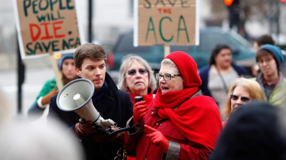 Organizer Tyler Murphy, left, looks on as Sandra Bennett expresses herself as concerned citizens gathered at Courthouse Plaza to protest Republican efforts to dismantle the Affordable Care Act in Lexington, Ky., Sunday, Jan. 15, 2017.