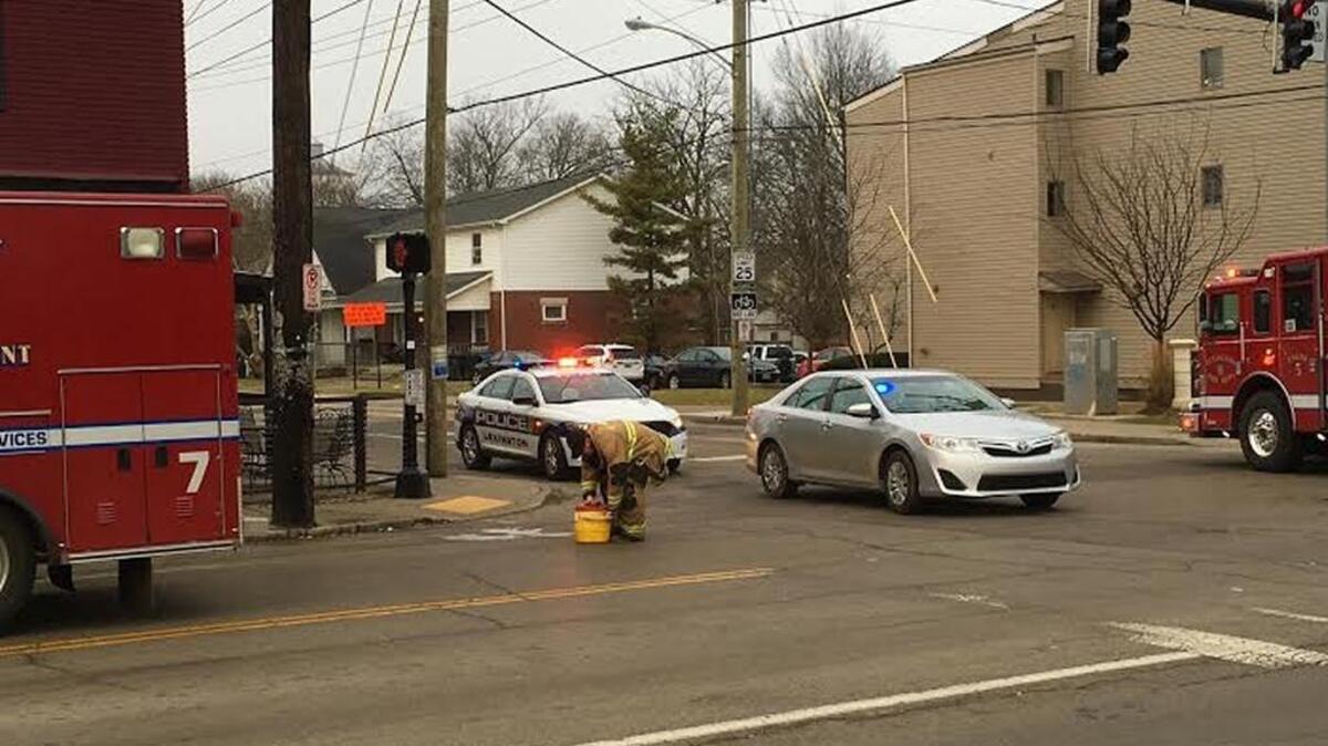 Emergency personnel washed the area where a pedestrian was struck by a car early Tuesday