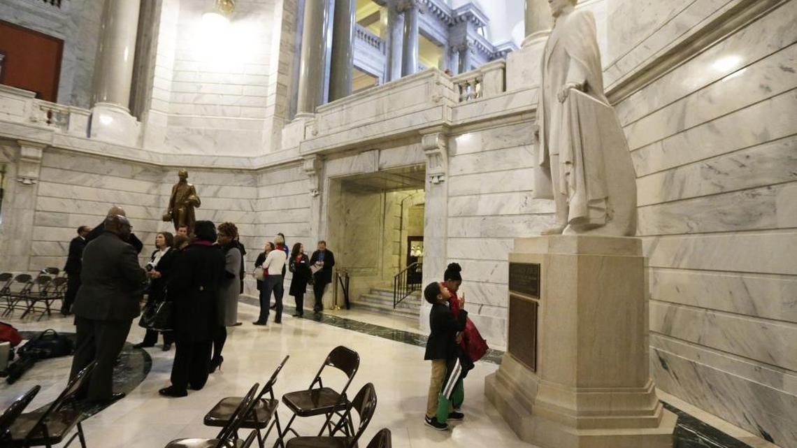 Avery Tandy, age eight, and her brother Solomon Tandy, age six, examined the statue of Jefferson Davis after the Black History Month Celebration at the Capitol Rotunda in Frankfort, Ky, on Feb. 10, 2016. The siblings attended the celebration with their parents.