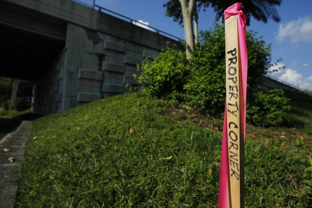 A property marker sits behind Main Street Baptist Church near the Jefferson Street Bridge in Lexington, Ky., Thursday, Sept. 21. 2017. The city of Lexington is attempting to tear down the Jefferson Street bridge to make room for an expanded Lexington Convention Center and a nearly 10-acre park. The new plans will eliminate a parking lot currently being used by Main Street Baptist Church.