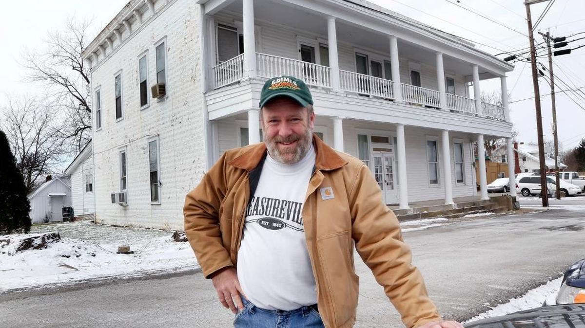 Mike Grimes stood in front of the old hotel in Pleasureville on Jan. 11.