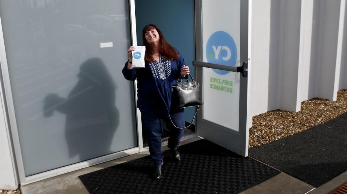 Diana Briggs, whose son, Ryan Briggs suffers from intractable epilepsy, leaves CY+ Medical marijuana Dispensary with a bag containing the medicine for him after being the first patron to buy a prescribed medical marijuana product at a dispensary on Thursday, Feb. 15, 2018 in Butler, Pa