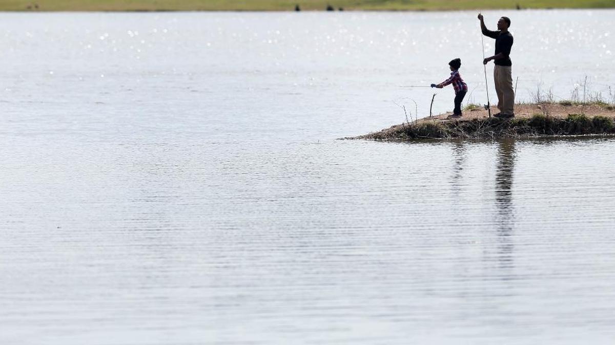 Quintin Wingate II fished with his 4-year-old son Quintin Wingate III in the reservoir at Jacobson Park on Richmond Road last March. Quintin said he wasn’t having much luck catching fish but was really there to teach his son the concept of fishing.