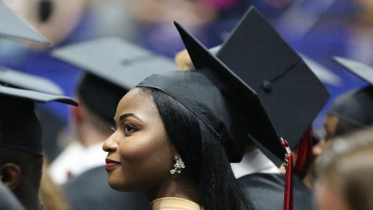 Charlotte Muyumba looked over to her family Wednesday during Paul Laurence Dunbar High School’s graduation ceremony at Rupp Arena in 2017.