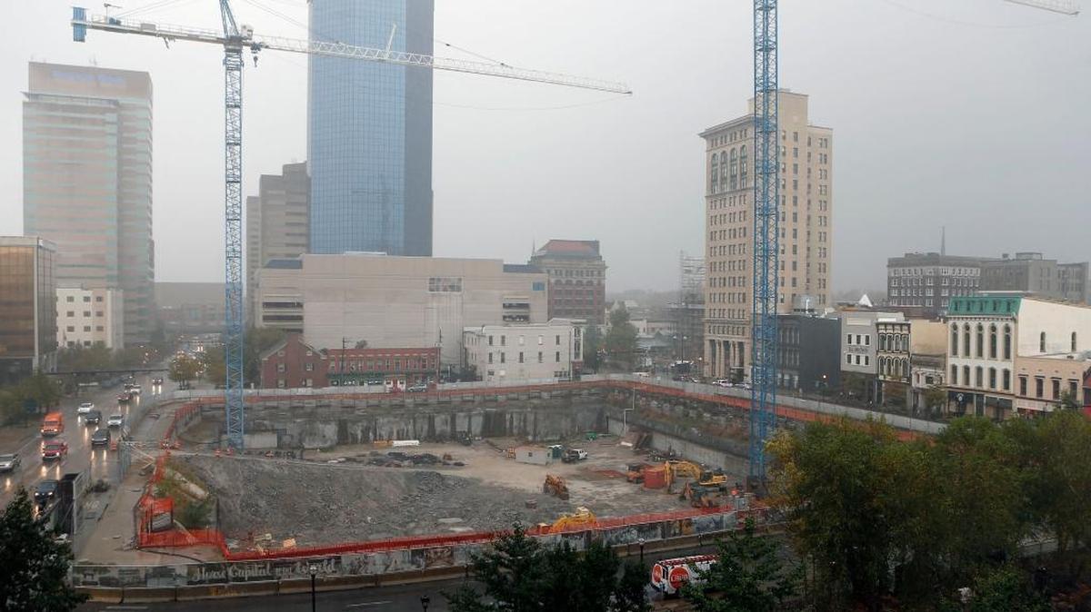 Construction continued in a heavy morning rain shower Thursday at the CentrePointe project in downtown Lexington.