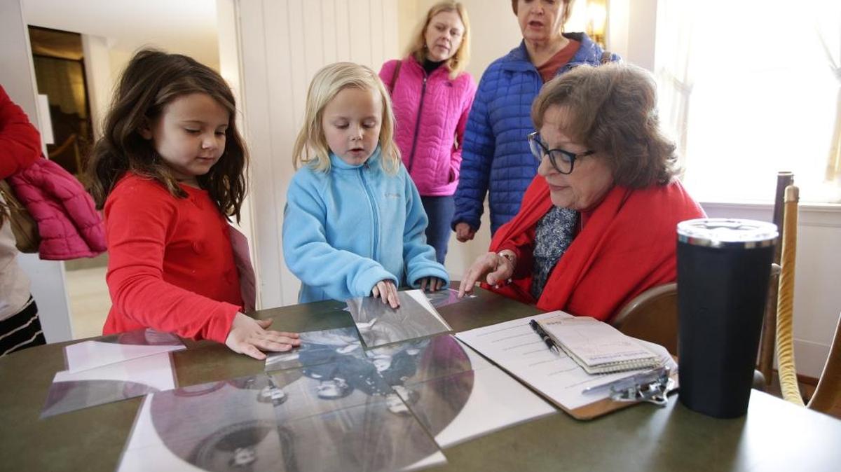 During the Presidents Day Family Event on Monday at Lexington’s historic Mary Todd Lincoln House, Sterrett Whitton, 5, left, and Harper Hamann, 7, worked on a photo puzzle of Abraham Lincoln and his family. Mary Todd, a Lexington native, married the future president in 1842.