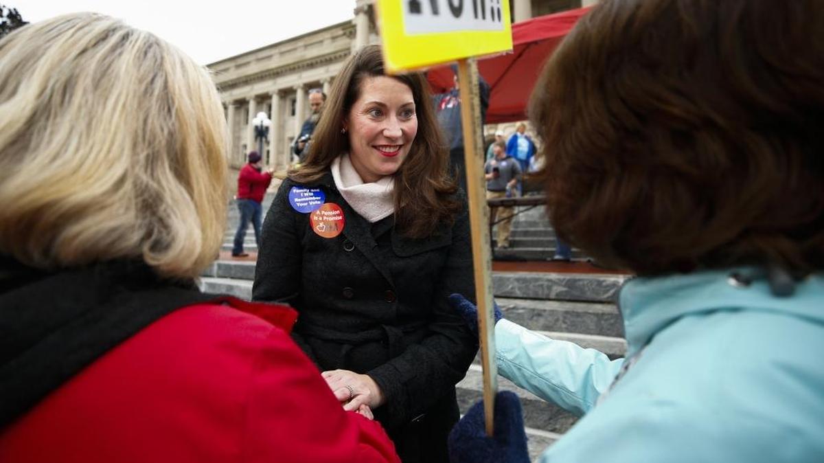 Secretary of State Alison Lundergan Grimes spoke with people attending a rally against a Republican proposal to reform the state’s pension system outside of the Capitol in Frankfort Nov. 1, 2017.