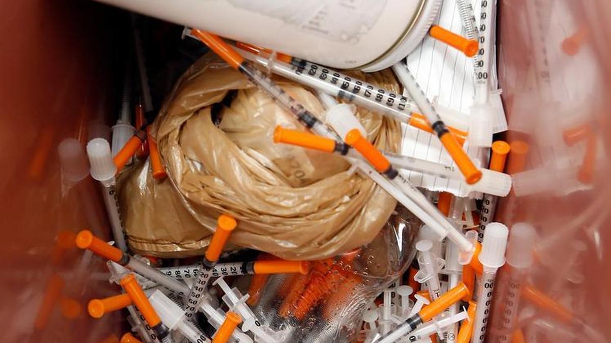 A can full of discarded needles Tuesday at the Lexington-Fayette County Health Department. The Fayette County needle exchange program has given out 21,693 clean needles and has collected 20,199 used needles in its first year of operation. The health department encourages people to bring their needles in a container, such as this plastic jar, for safety.