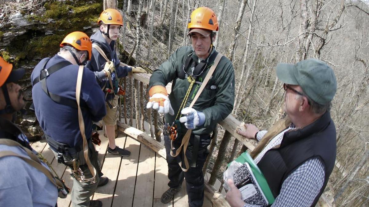 In this 2013 file photo, Boone Creek owner Burgess Carey, center, talked with zipline tour customers at Boone Creek Outdoors in Lexington.