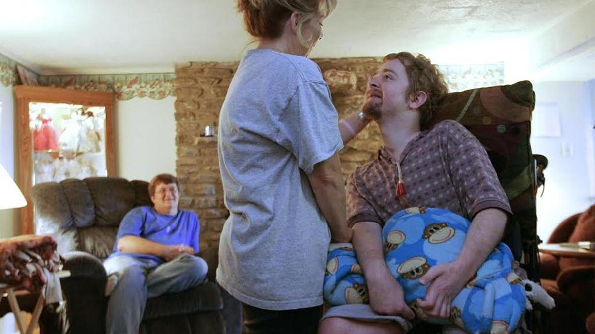 Mark Portwood looked at his mother with a smile as she caressed his head at their home in Lexington on Friday, September 16, 2005.