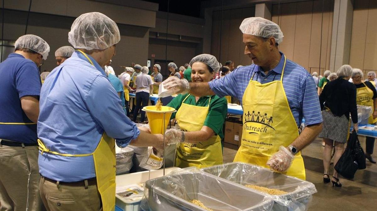 Kentucky's House Leader Rep. Rocky Adkins pours pasta in to a package as members of the Southern Leadership Conference packaged more than 80,000 meals for God's Pantry Food Bank as part of the group's Mark Norris Campaign Against Hunger initiative in Heritage Hall.