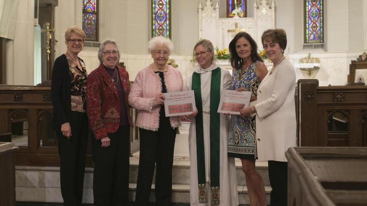 A book documenting the needlework of Christ Church Cathedral will be available in November. From left are Jo Ellen Hayden, book editor and designer; Carolyn Ware, cathedral archivist; Luanne Crehore, to whom the book is co-dedicated along with the late Mary Breeden; the Rev. Carol Wade, dean and rector of the cathedral; Lenore Breeden, representing the family of Mary Breeden; and Dana Davis, chair of the Needlework Book Committee.