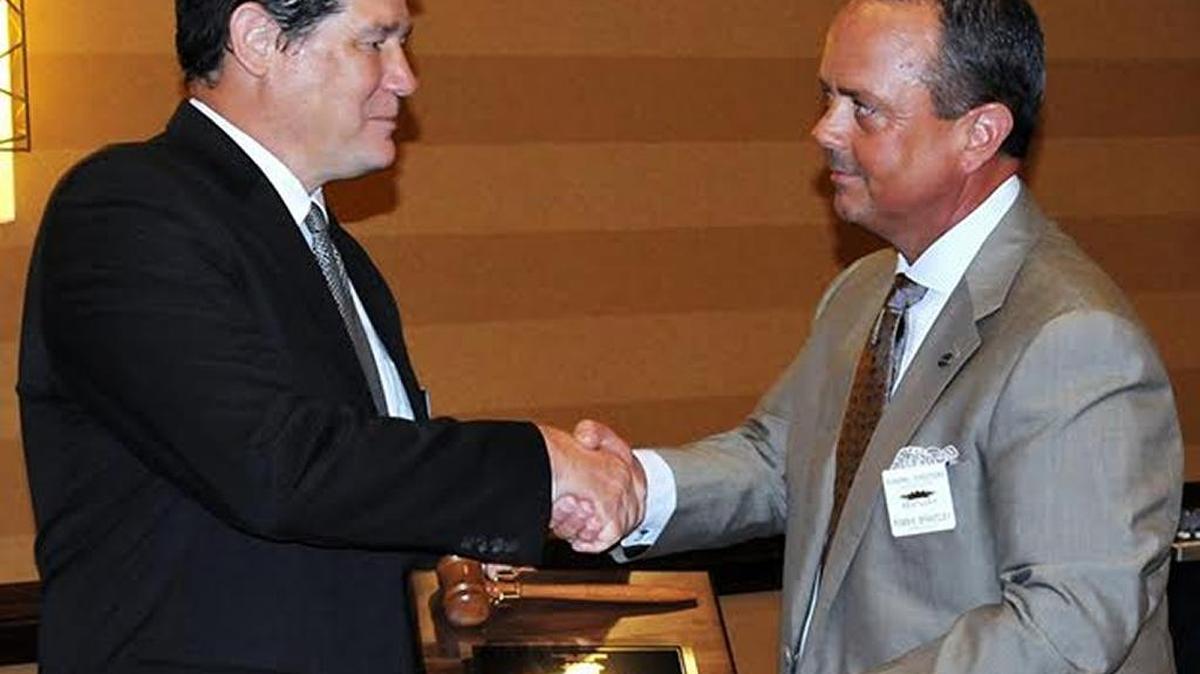 David West, left, was presented with a gavel as the new president of the Funeral Directors Association of Kentucky by immediate past president Robbie Brantley.