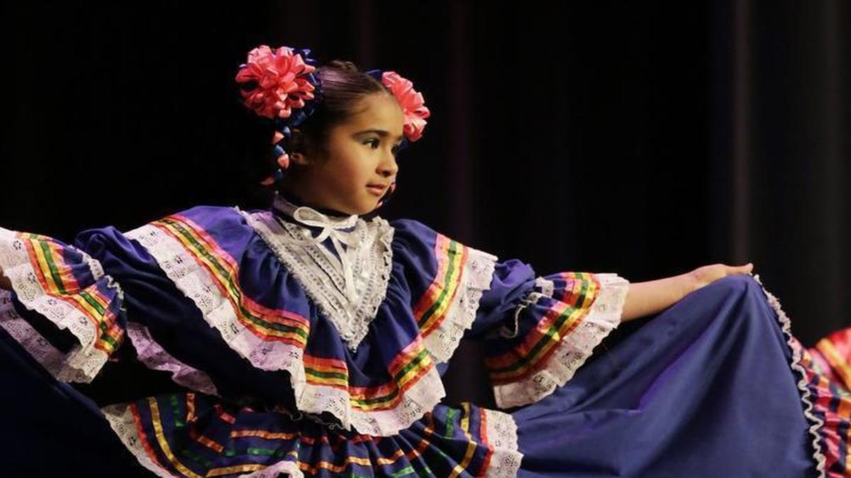 Alondra Ali, left, age 9, and Hillary Avelar, age 10, performed a Mexican folk dance during the Diversity Fair at Bryan Station High School in Lexington, Ky., on March 22, 2016.