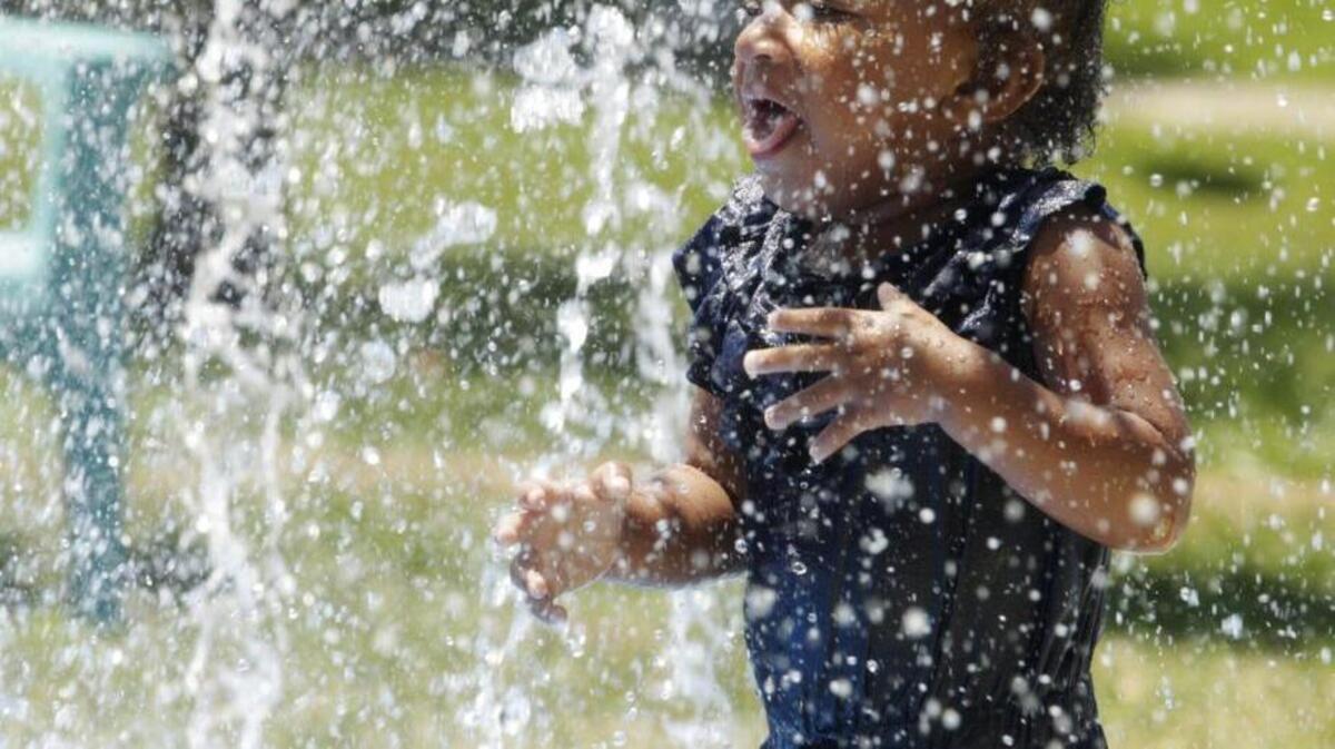 Kay-Kay Lewia, 18 months, enjoyed the opening of the new temporary splash park at Northeastern Park.
