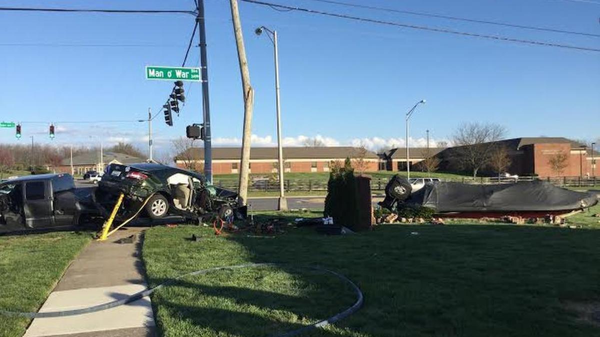 An accident involving a car and a truck towing a boat injured a woman and damaged an electrical pole Monday afternoon at Man o’ War and Trent boulevards. The boat, right, went sailing off the trailer into a small brick wall.