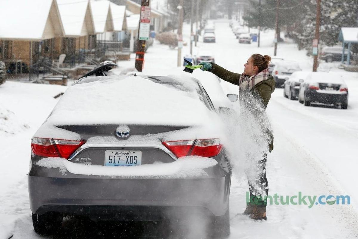 Alexi Mojsejenko cleared the snow off her car before heading to work Tuesday morning.