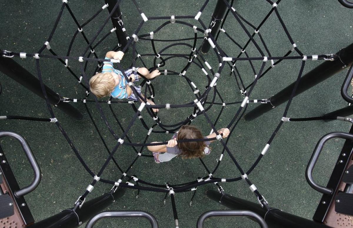 Four-year-old Woods Pugh, left, and Kendall Pugh, 7, climbed the equipment in the playground at Jacobson Park on August 2, 2016.