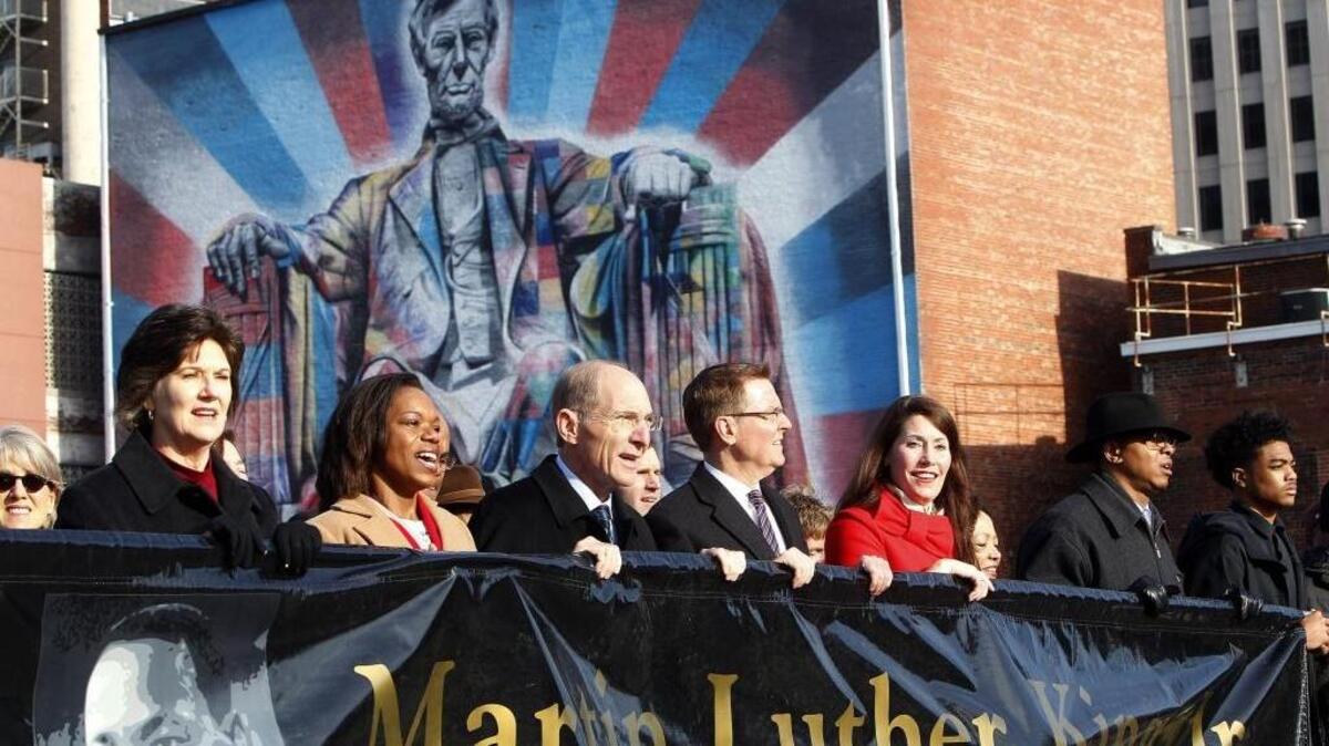Civic leaders lead marchers through downtown during the 44th annual Freedom March to celebrate the legacy of civil rights pioneer Dr. Martin Luther King Jr. in Lexington, Ky., Monday, Jan. 16, 2017.