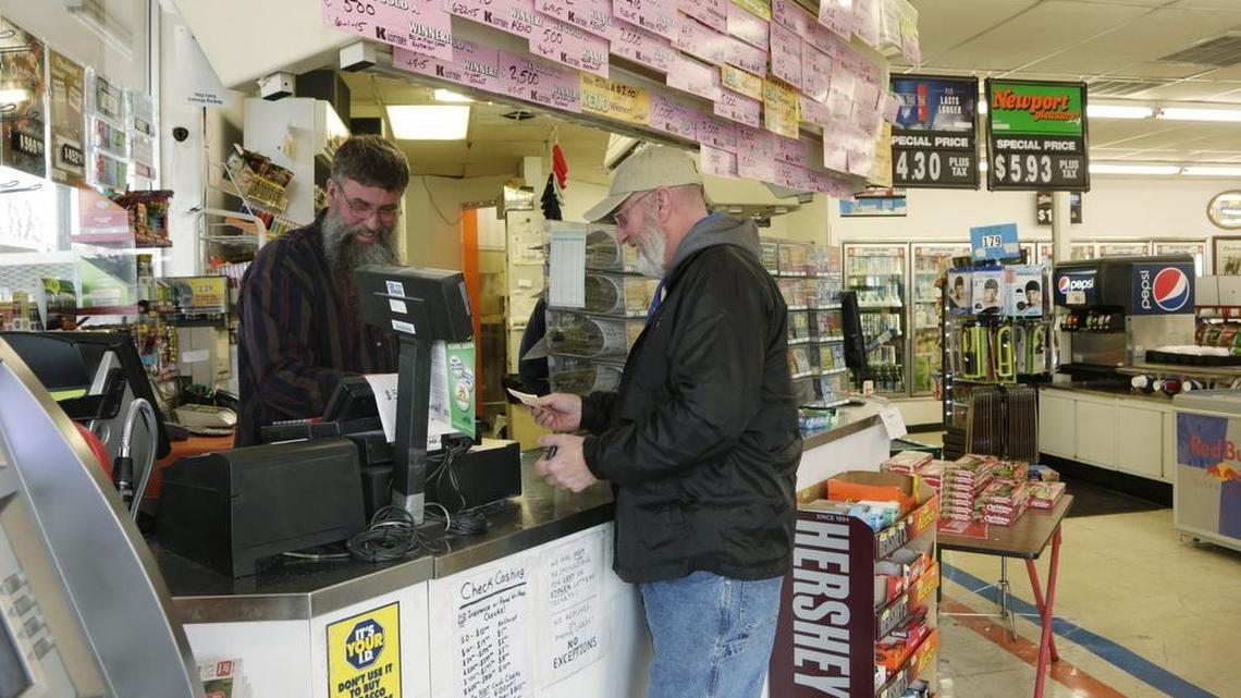Kenny Evans bought Powerball ticket from Stephen White at Dairy Mart on Reynolds Road in Lexington Friday, Jan. 8, 2016. The estimated jackpot had reached $800 million by Friday. The Dairy Mart is among the top five lottery retailers in the state.