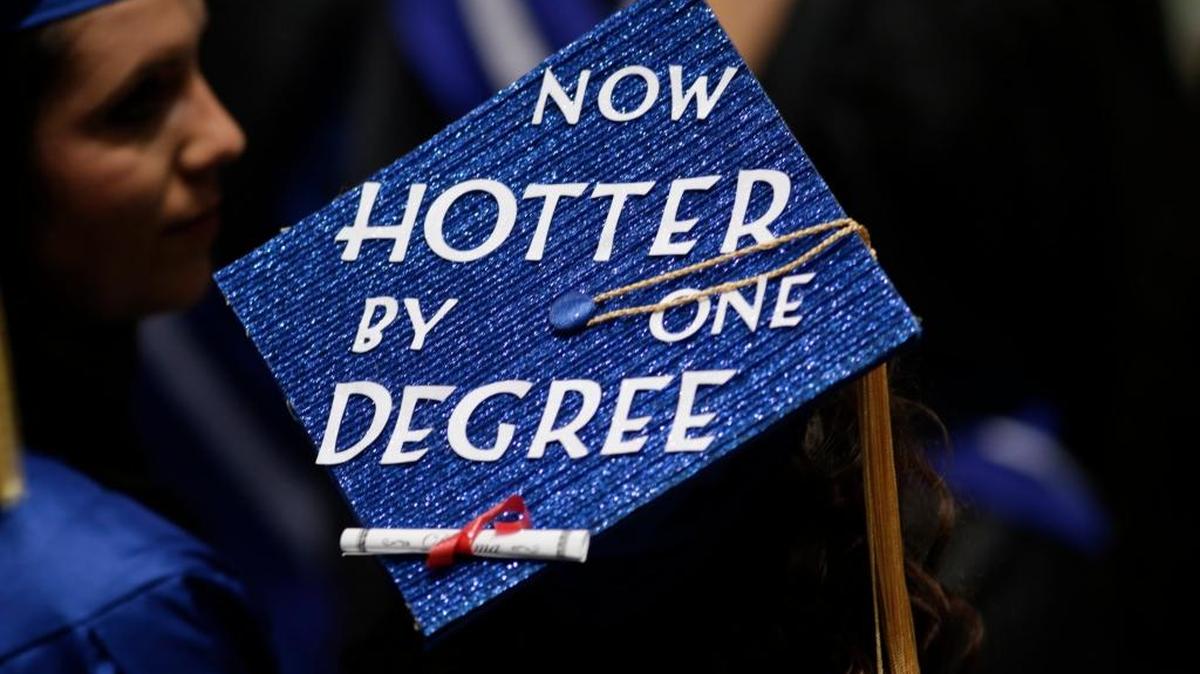 A student's decorated cap read “Now hotter by one degree” during the Class of 2015 UK graduation ceremonies at Rupp Arena in Lexington on May 9, 2015.