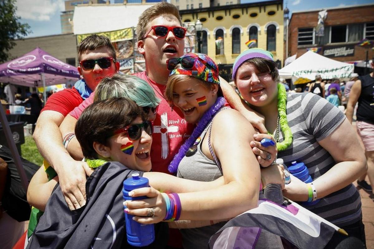 Michael Cheney of Lexington, center, with Word of Hope Lutheran Church, gave “free hugs” to attendees.