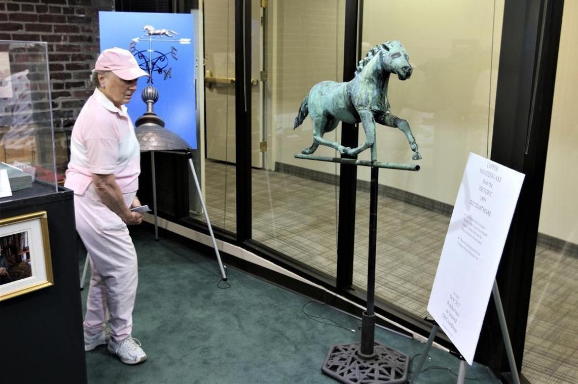 Phyllis Hasbrouck of Lexington browsed the displays, which included a copper weather vane from the old Fayette County Courthouse, at the Lexington History Museum's Pop-Up Exhibit at Victorian Square on May 19.