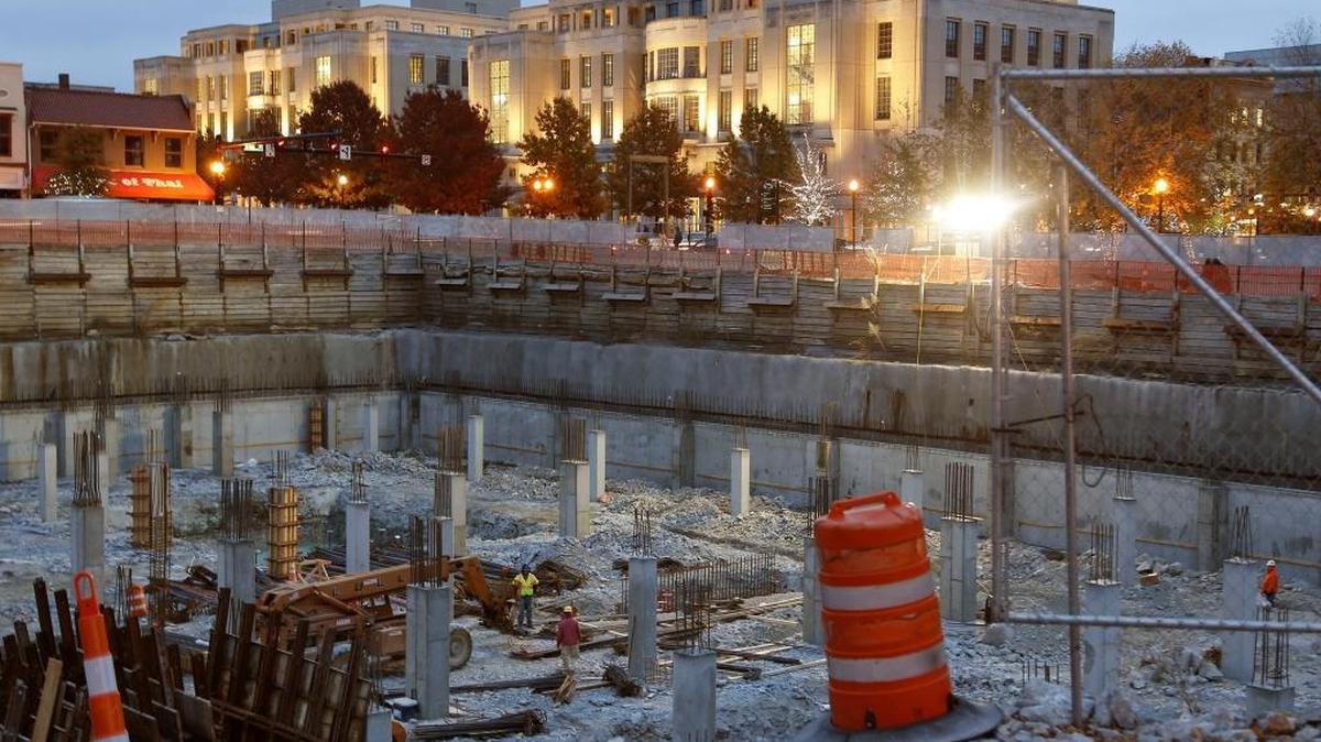 The three-story underground parking garage is taking shape at the CentrePointe site in downtown Lexington. Work started Monday before sunrise, so large lights were used to illuminate the site. The courthouse complex is in the background. Work at the long-stalled CentrePointe development picked up in late October after D.W. Wilburn Construction signed a contract to build the more than 700-space garage.