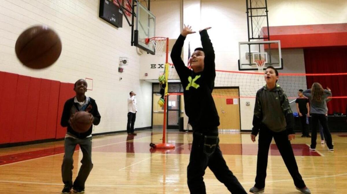 From left, Pekorce Gabriel, Malachi Mendoza and Gerardo Sangabriel, all age 12, threw baskets during gym class at Bryan Station Middle School. The school is taking several measures to raise student achievement and close the achievement gap between disabled, minority and poor students and others.