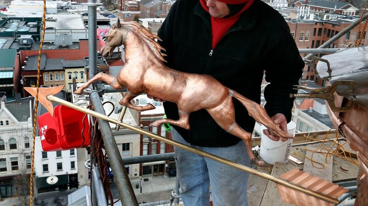 Mark Hardin, with American Roofing and Sheet Metal, held the 4-foot copper horse that will sit of the top of the weather vane.