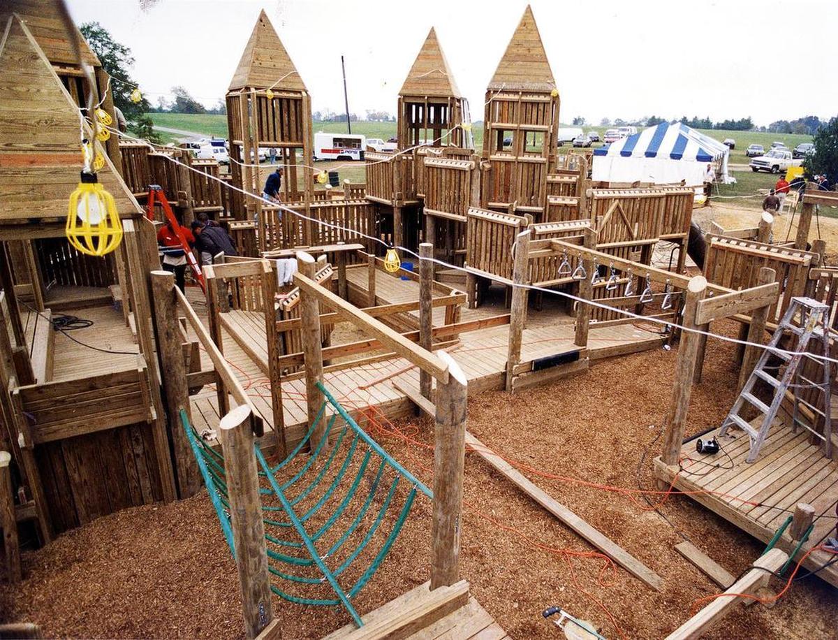 From our historical photo blog, KyPhotoArchive.com: Construction of the wooden playground structure at Jacobson Park in Lexington, Oct. 11, 1993. The popular mazelike playground at the Richmond Road park was Lexington’s third creative playground. Picadome Elementary School playground was the first, followed by the Shillito Park project. About 2,500 volunteers contributed to the completion of the playground. When it opened about two weeks later, it was the largest playground n Kentucky, featuring 30,000 square feet of slides, swings, turrets, bridges and hiding nooks.
