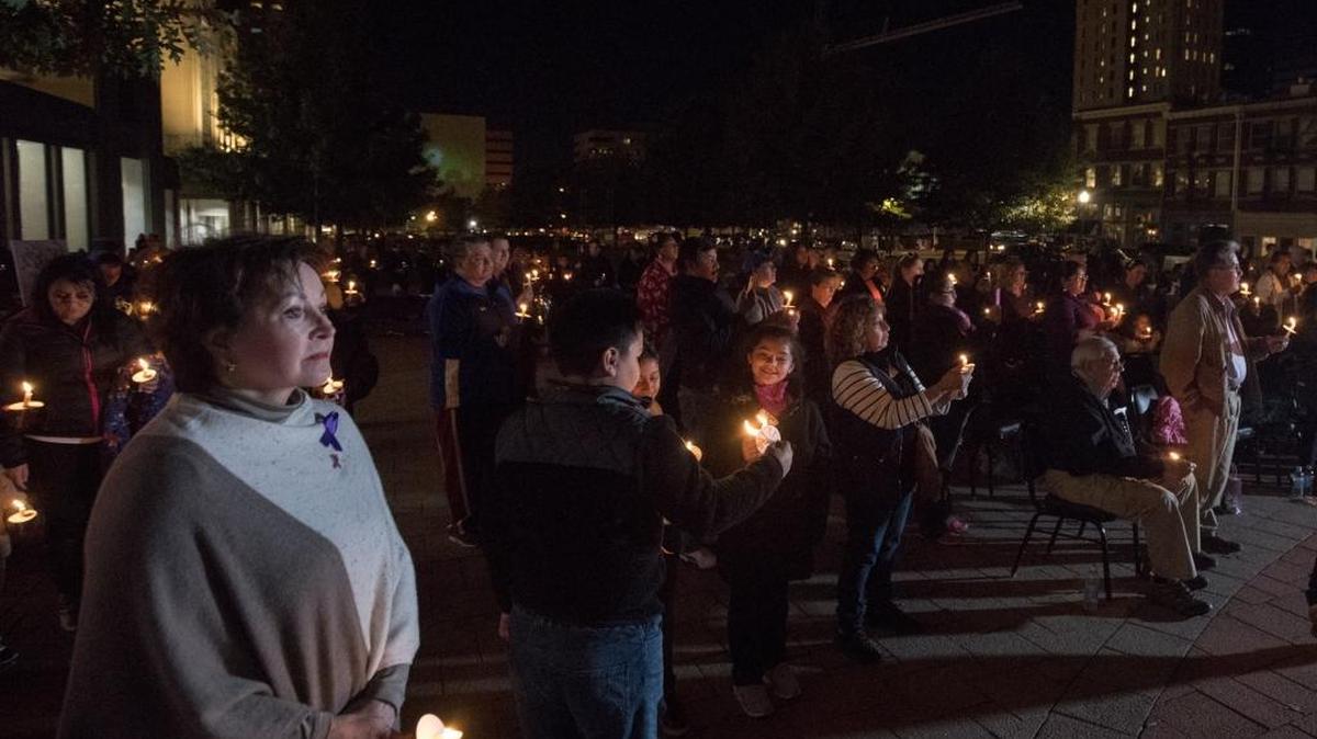 Those gathered at the vigil lit candles for domestic violence victims.