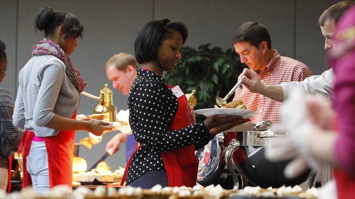 Volunteer server Leea Johnson fixed a plate for a guest at the Salvation Army dinner.