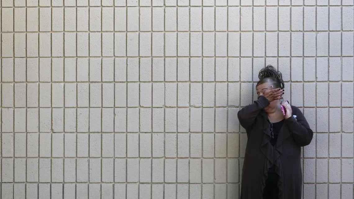 A woman wipes her tears at a community center where family members are gathering to pick up survivors after a shooting rampage that killed multiple people and wounded others at a social services center in San Bernardino, Calif., Wednesday, Dec. 2, 2015. (AP Photo/Jae C. Hong)