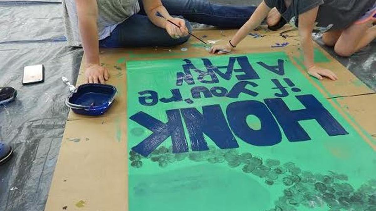 Natalie Hagen and her daughter, Violet, 7, worked on a tribute to hard-working farmers of America for the Nicholasville Paint-the-Town Banner Event on July 20 at the City-County Park. Organizers said 136 artists created 72 banners that will be displayed on Nicholasville’s Main Street in the fall.