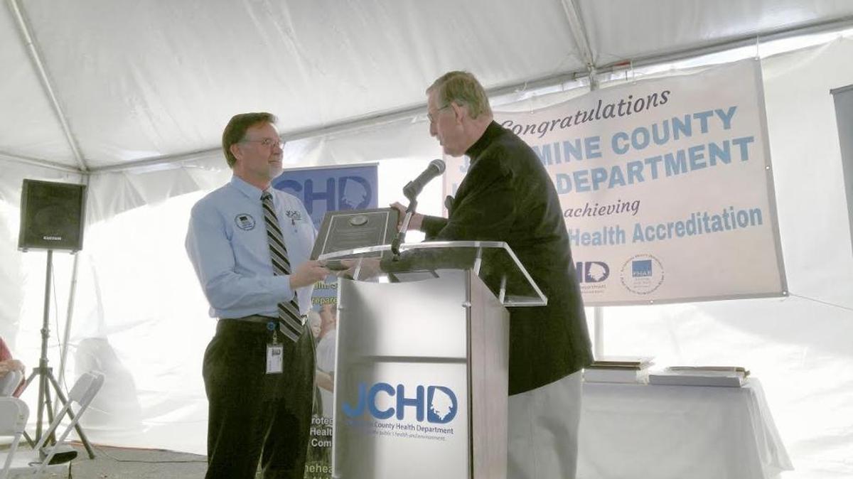 Jessamine County Public Health Director Randy Gooch, left, accepted an accreditation plaque from National Public Health Accreditation Board Director F. Douglas Scutchfield at a ceremony held in Nicholasville.