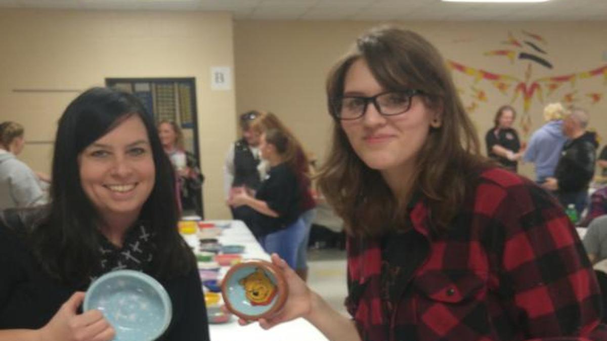 Providence School English teacher Jessie Law, left, and senior student Emily Bush showed off their dinnerware at the Empty Bowls Luncheon.