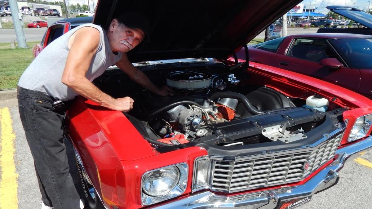 Bob Eiser of Nicholasville made adjustments to his 1972 Chevrolet Monte Carlo at the Classic Car Cruise-In at the U.S. Route 27 Double Kwik BP on July 8. Eiser said the 496-cubic-inch engine gets only six miles per gallon. About 60 classic and collectible vehicles participated in the event.