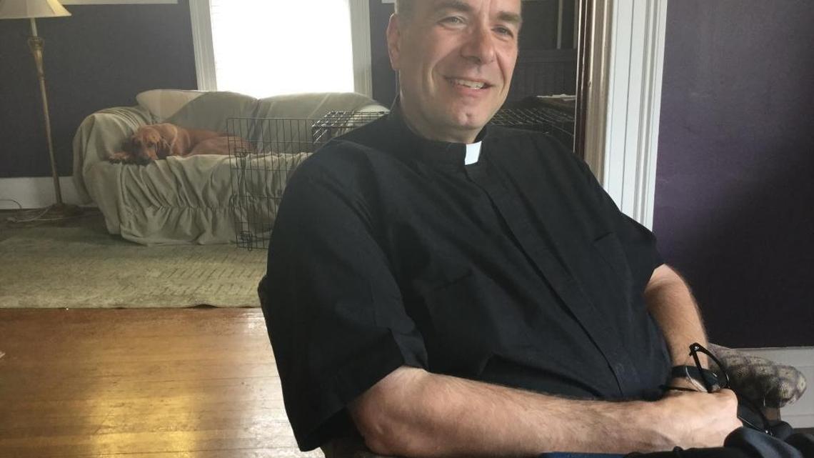 The Rev. Jim Sichko, pastor of St. Mark Catholic Church in Richmond, will leave the parish after 12 years to become an evangelistic speaker for the Catholic Diocese of Lexington. His bloodhound, Gracie, snoozes in the background.
