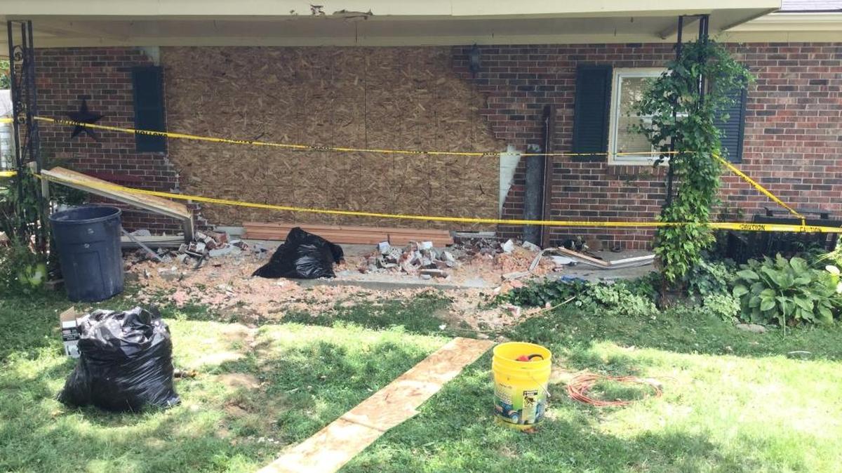 The gaping hole left by a truck had been boarded up Tuesday at the home of Russell and Joan Hurt. Russell Hurt, 81, suffered cuts to the head and arm, but his daughter, Ann Nebraski, was admitted to University of Kentucky Chandler Hospital with two broken legs.