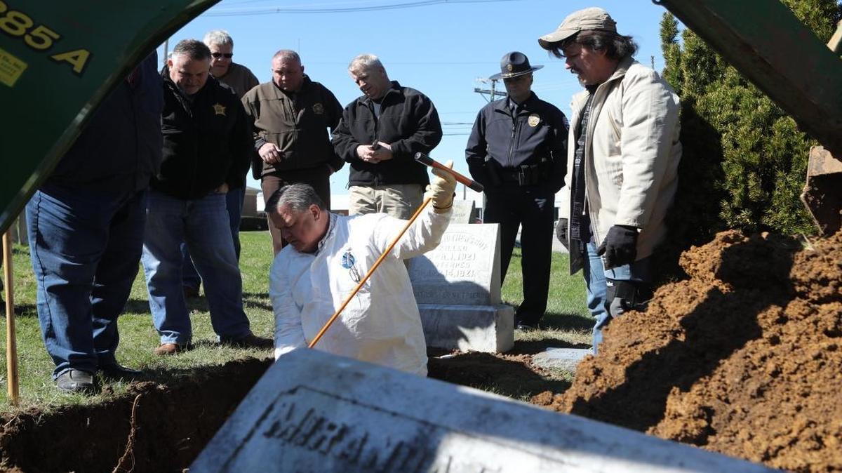 Fayette County Coroner Gary Ginn used a prod to check for remains March 10 at Georgetown Cemetery during the exhumation of an unidentified teen known as “Some Mother’s Boy” 96 years after the teen was struck and killed by a train.
