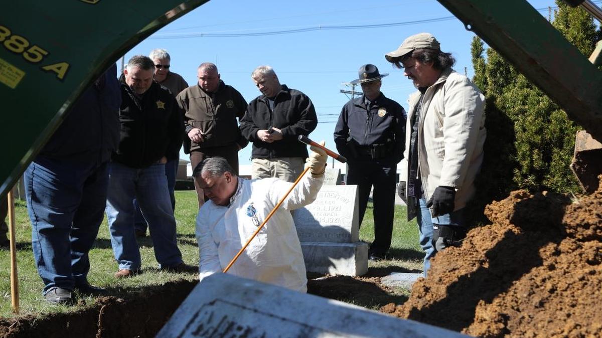 Fayette Co. coroner Gary Ginn uses a prod to check for remains during the exhumation of the unidentified teen known as ‘Some Mother’s Boy,’ 96 years after he was struck and killed by a train, at Georgetown Cemetery in Georgetown, Ky., Friday, March 10, 2017.