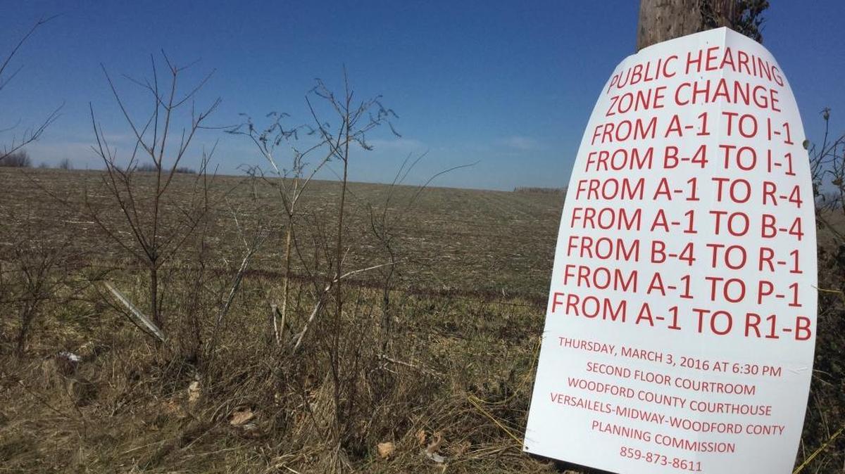 A sign advertises the Thursday night public hearing on Edgewood Farm before the Versailles-Midway-Woodford County Planning Commission. The farm on the eastern edge of Versailles might be rezoned for apartments, single-family houses, retail businesses, light industry and perhaps a new hospital.