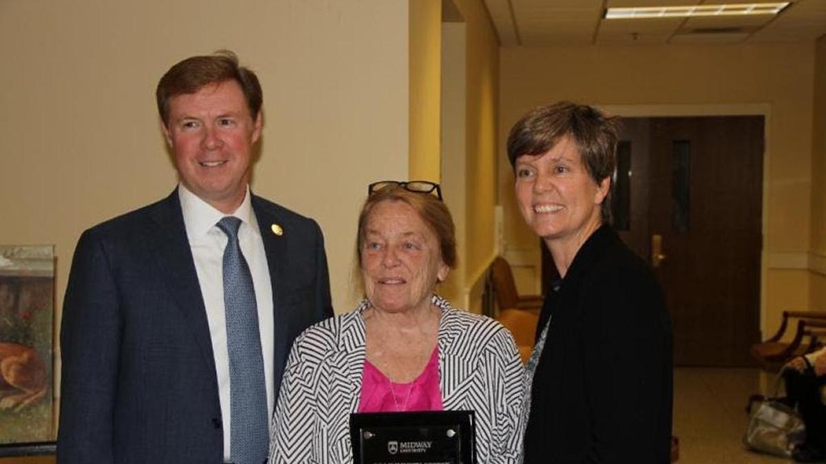 Dr. John P. Marsden, left, president of Midway University and Ellen D. Gregory, right, vice president of marketing and communications at Midway University, present the 2016 Community Spirit Award to Joyce Evans.