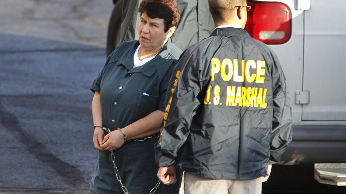 U.S. Marshals escorted Azra Basic, left, into the federal courthouse in Lexington, Ky., on Thursday, March 17, 2011, to appear on charges of committing war crimes.